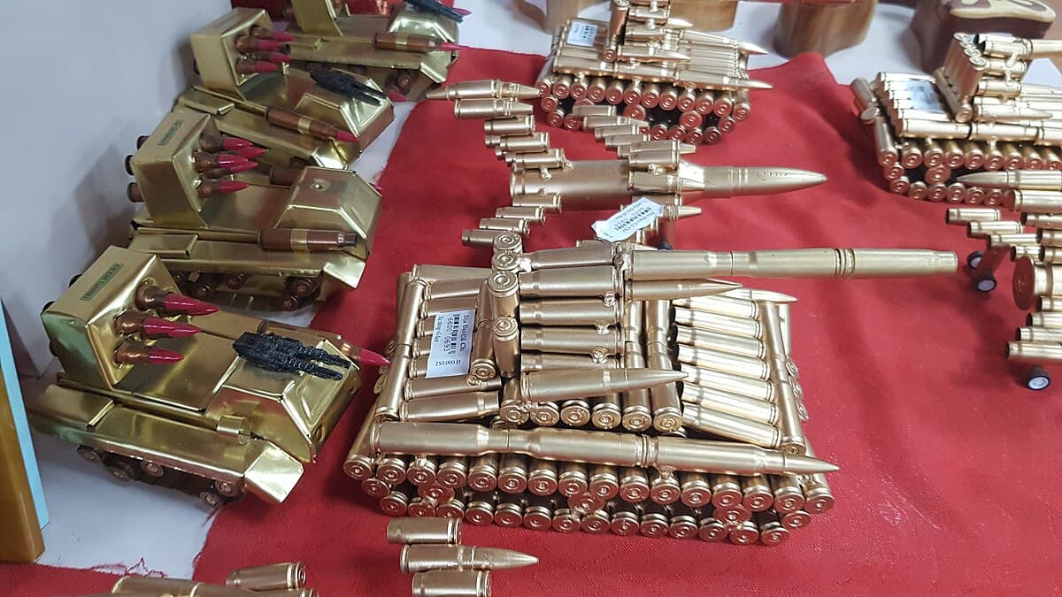 Entry to a restored Cu Chi Tunnel with a guide demonstrating how to enter