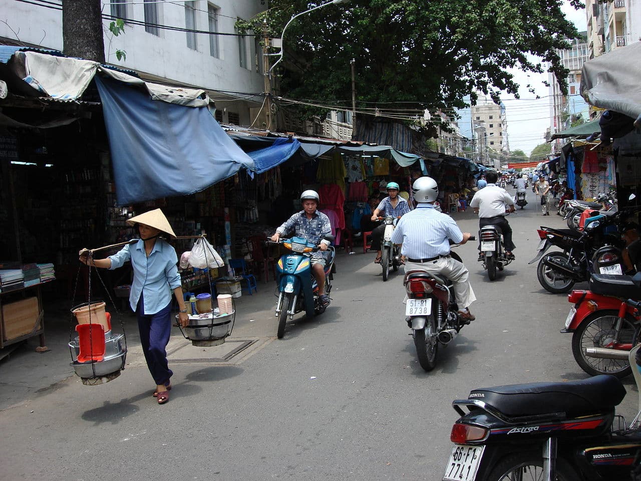 A Vietnamese street vendor accepting a QR-code payment — the everyday connectivity baseline