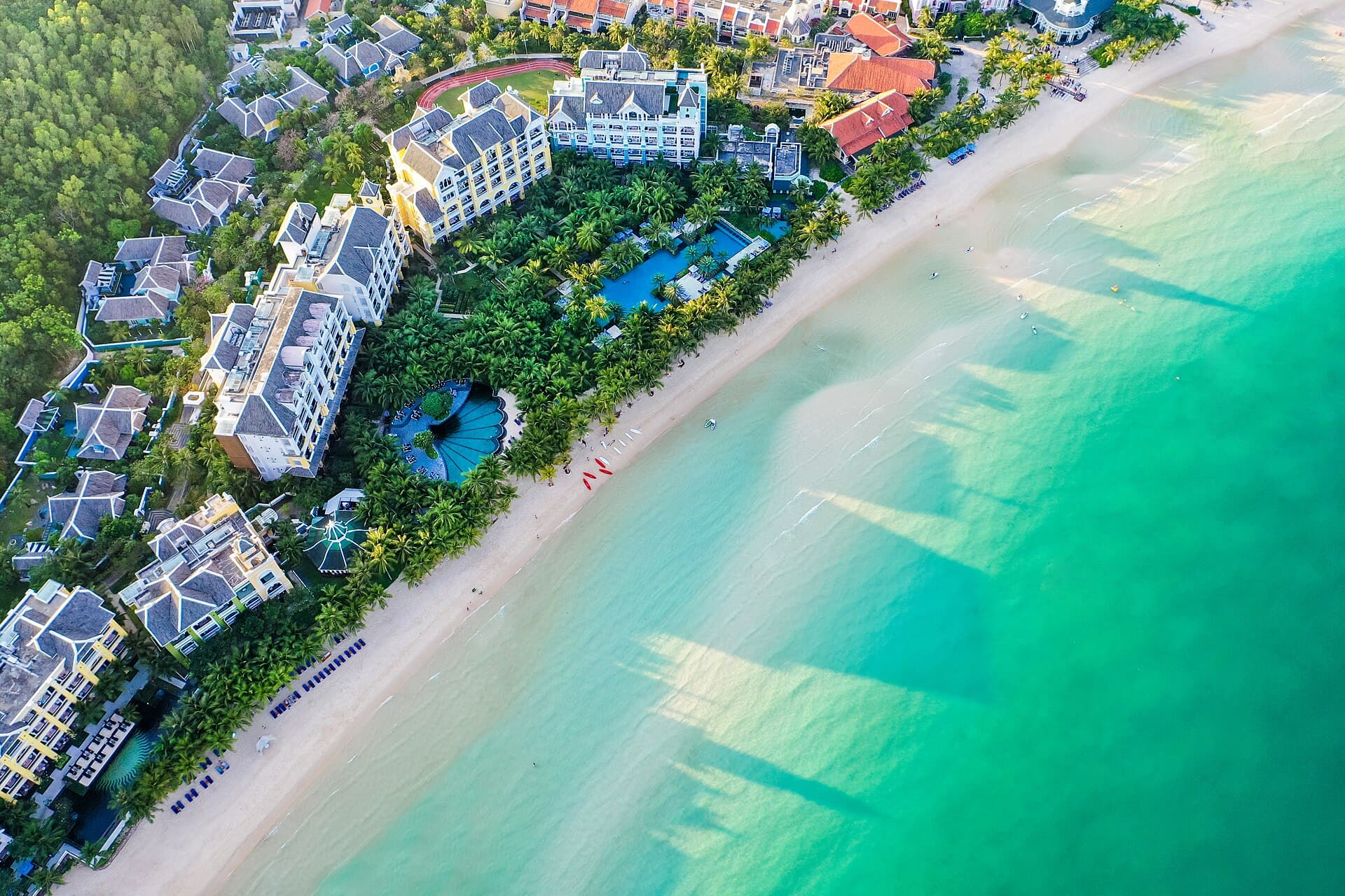 Aerial view of JW Marriott Phu Quoc Emerald Bay resort and Bai Kem beach — the flagship family resort on Vietnam's island south coast