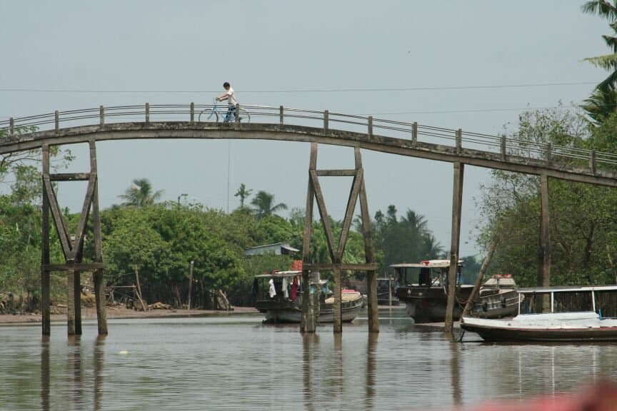 A small bridge over a Vietnamese canal — community-based tourism infrastructure