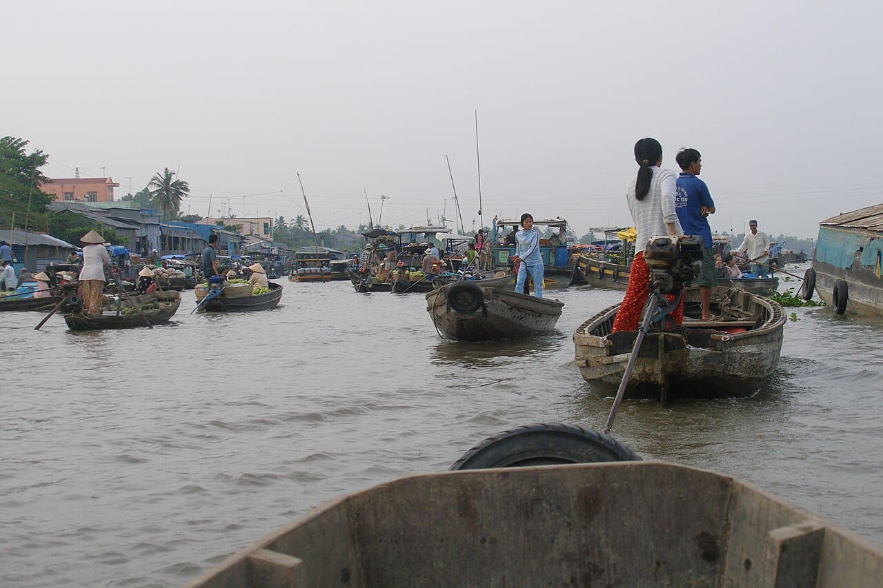 Floating market in Can Tho on the Mekong Delta — boats laden with produce trading in the middle of the river, a signature stop on any multi-day Vietnam itinerary