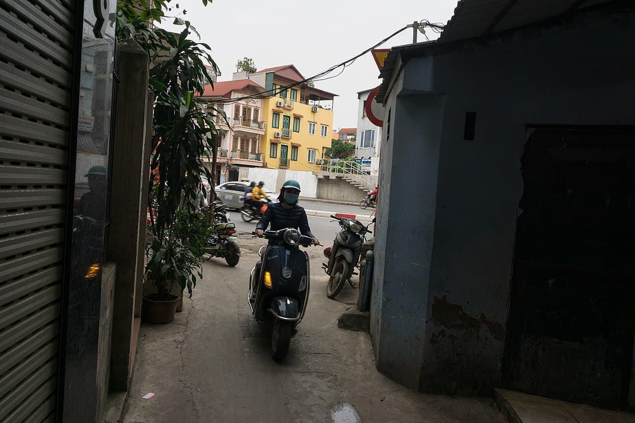 A row of rental scooters lined up outside a shop in Hoi An