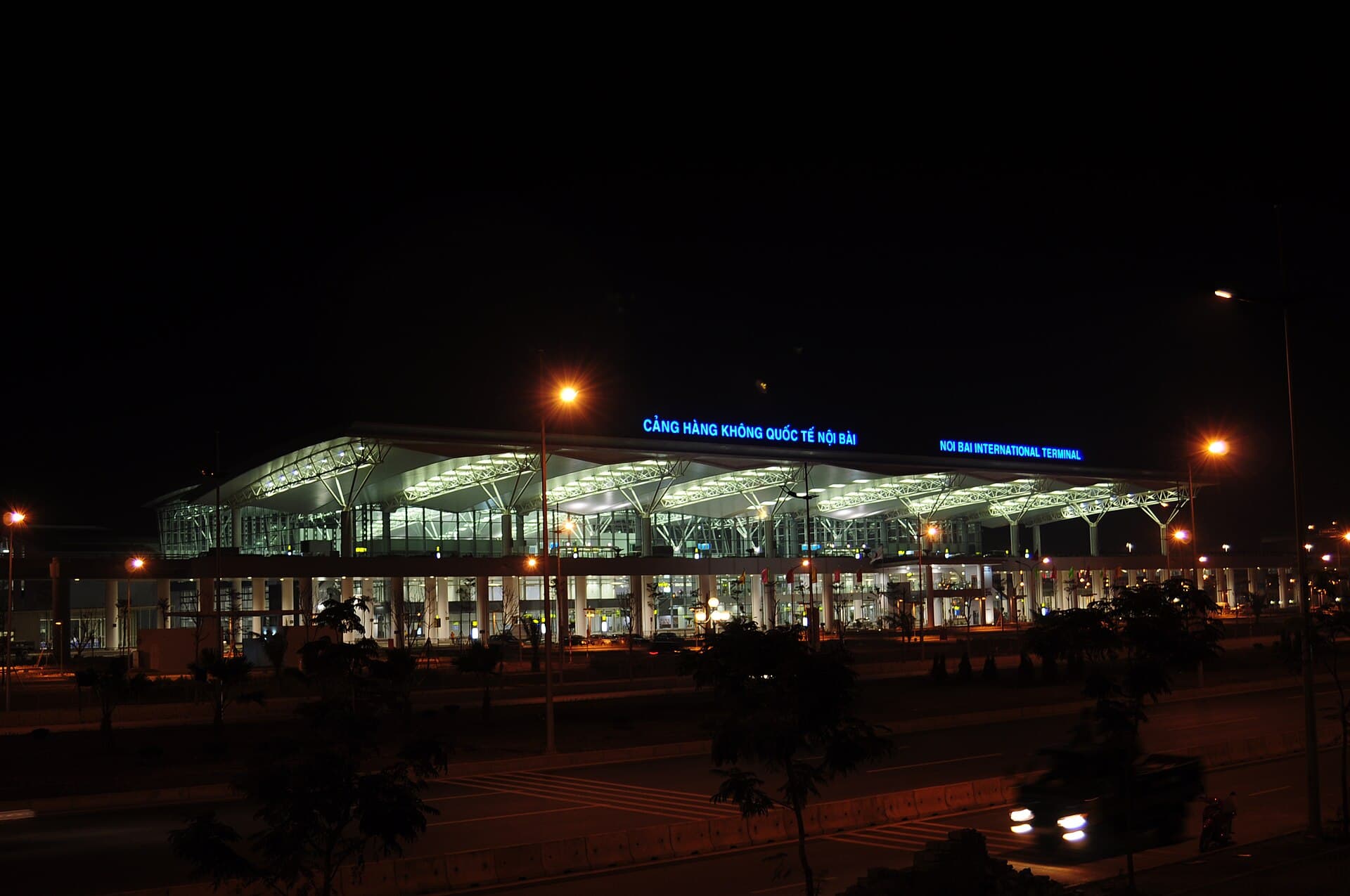 Hanoi's Noi Bai International Airport Terminal 2 at night — the entry point where the ~21M international arrivals counted in Vietnam's tourism-revenue accounts pass through