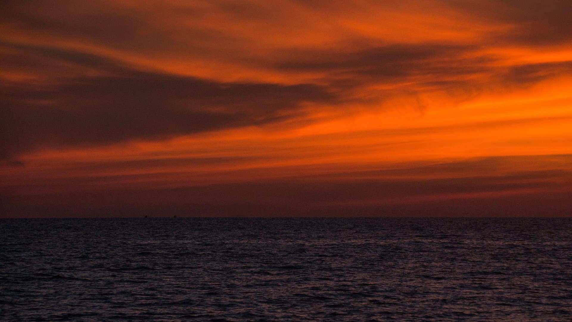 A deep orange sunset sky over the calm sea off Long Beach on Phu Quoc's west coast