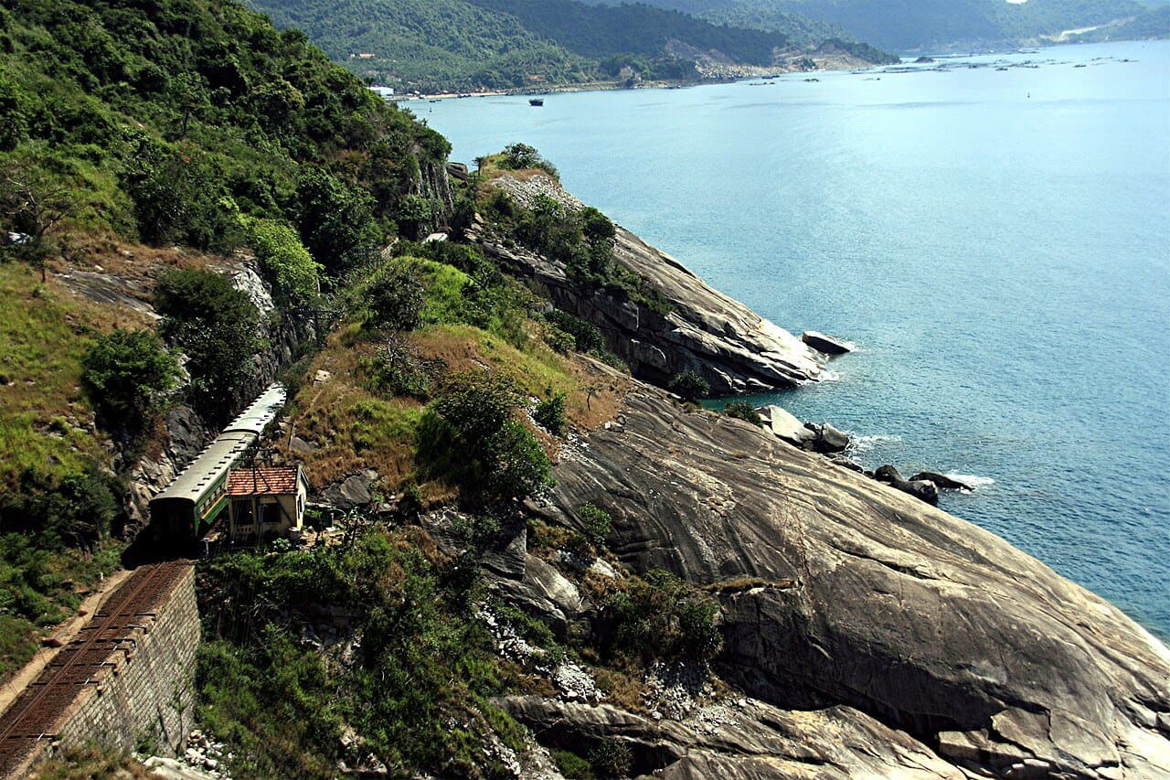 A Reunification Express train hugging the central Vietnamese coastline — the Hanoi-Hoi An rail route