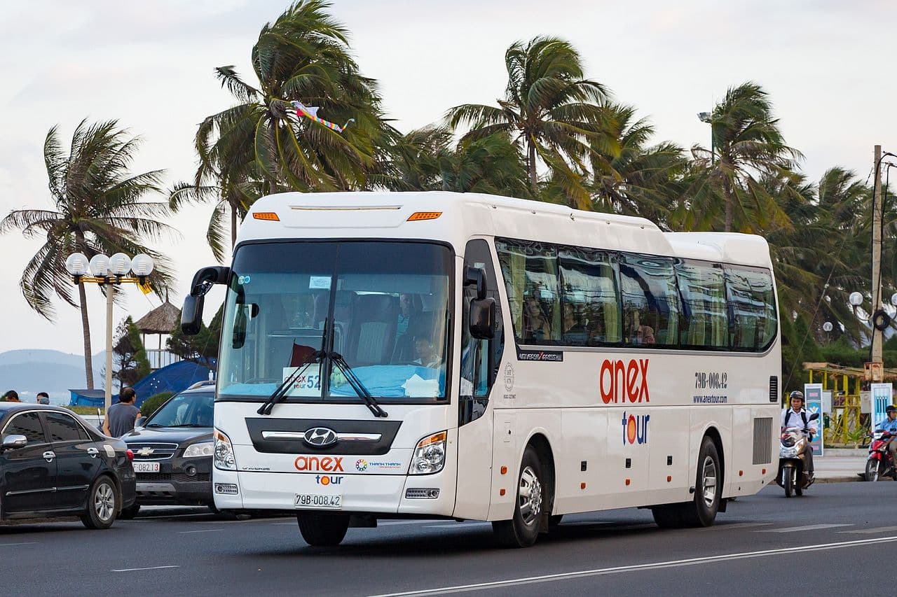 A Sinh Tourist open-tour bus loaded for departure from HCMC's backpacker district