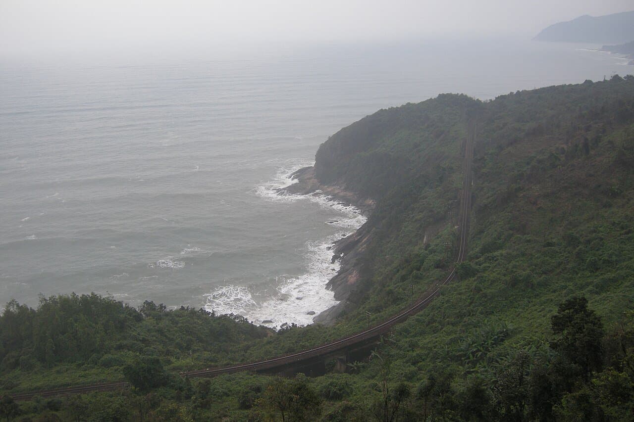 Vietnam's North-South Railway curving along the Hai Van coastline — the central reference axis of the country's travel-time grid