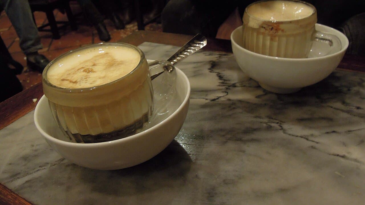 A cup of Vietnamese egg coffee with foamy yellow topping — Hanoi's signature drink