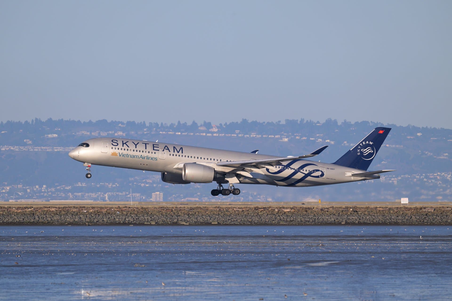 A Vietnam Airlines Airbus A350-900 in SkyTeam livery on approach — the national carrier and one of the main ways the 24 visa-exempt nationalities and 90-day e-visa holders reach Vietnam in 2026