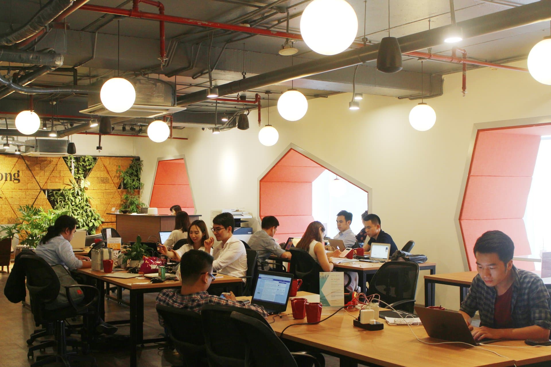 Travelers working in a Vietnamese coworking space — the slow-traveler and digital-nomad demographic