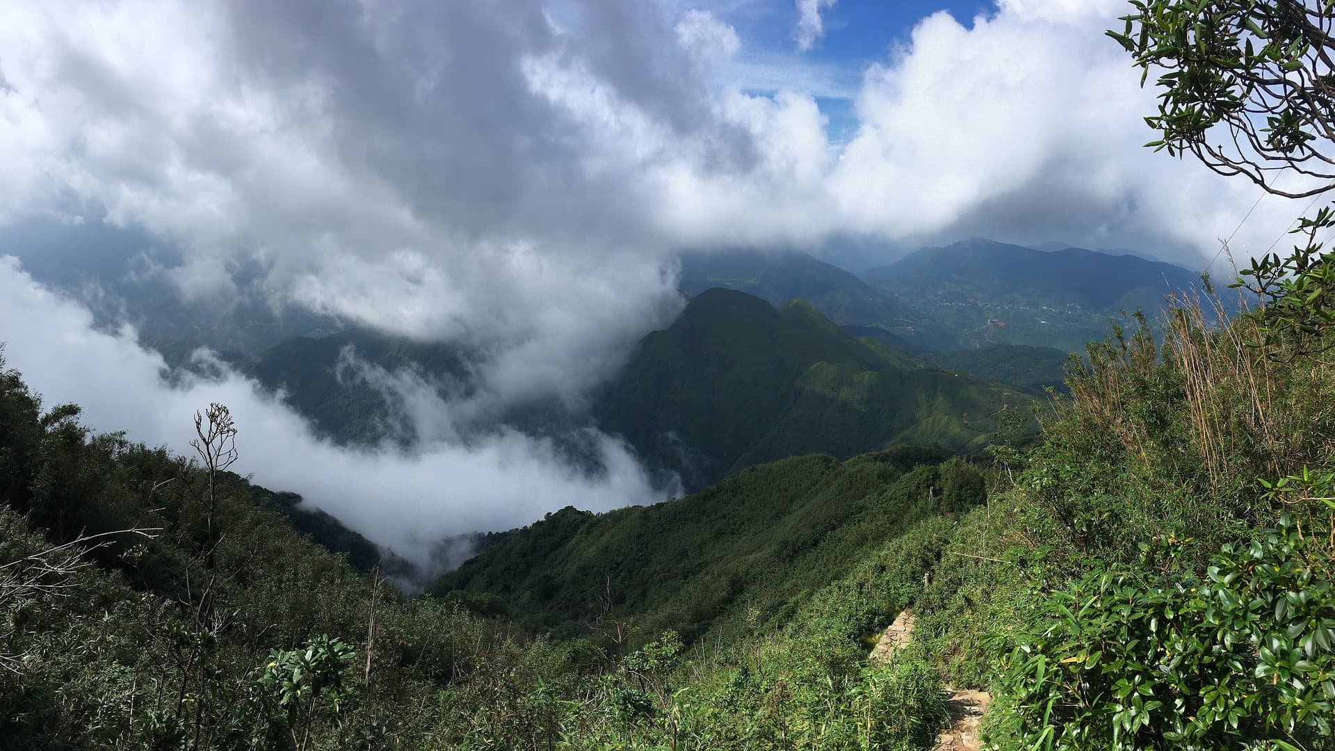 Clouds spilling over the forested ridges of the Hoang Lien Son range near Sa Pa, the mountains where Vietnam's rare snow falls